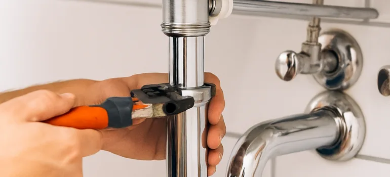 Plumbing maintenance checklist for landlords – professional London plumber inspecting pipework in a rental property